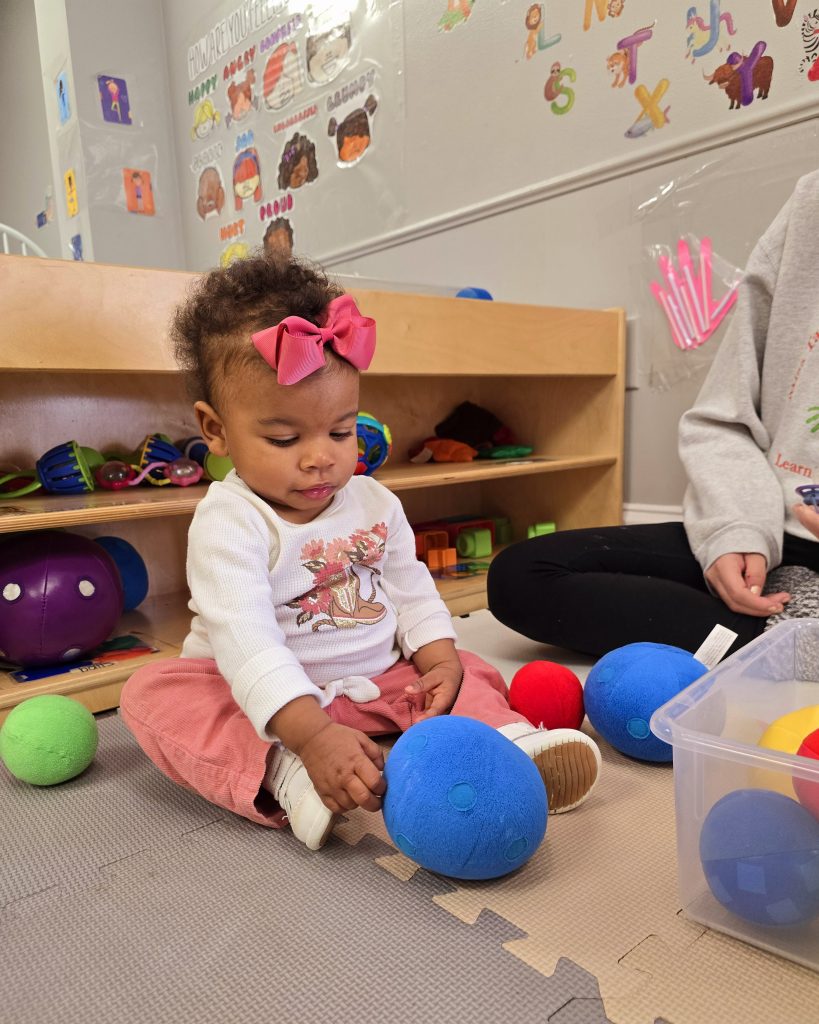 child playing with plush toy
