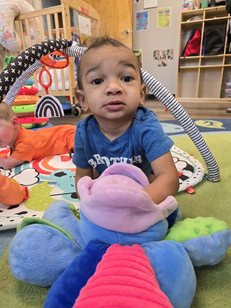child playing with plush toy